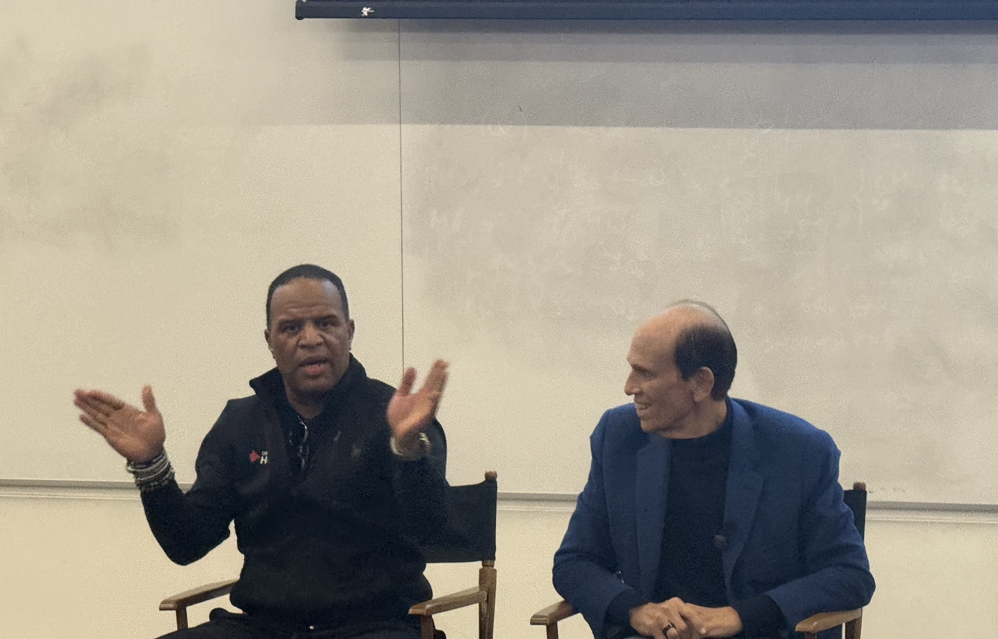 John Hope Bryant speaking beside Michael Milken during their fireside chat at USC